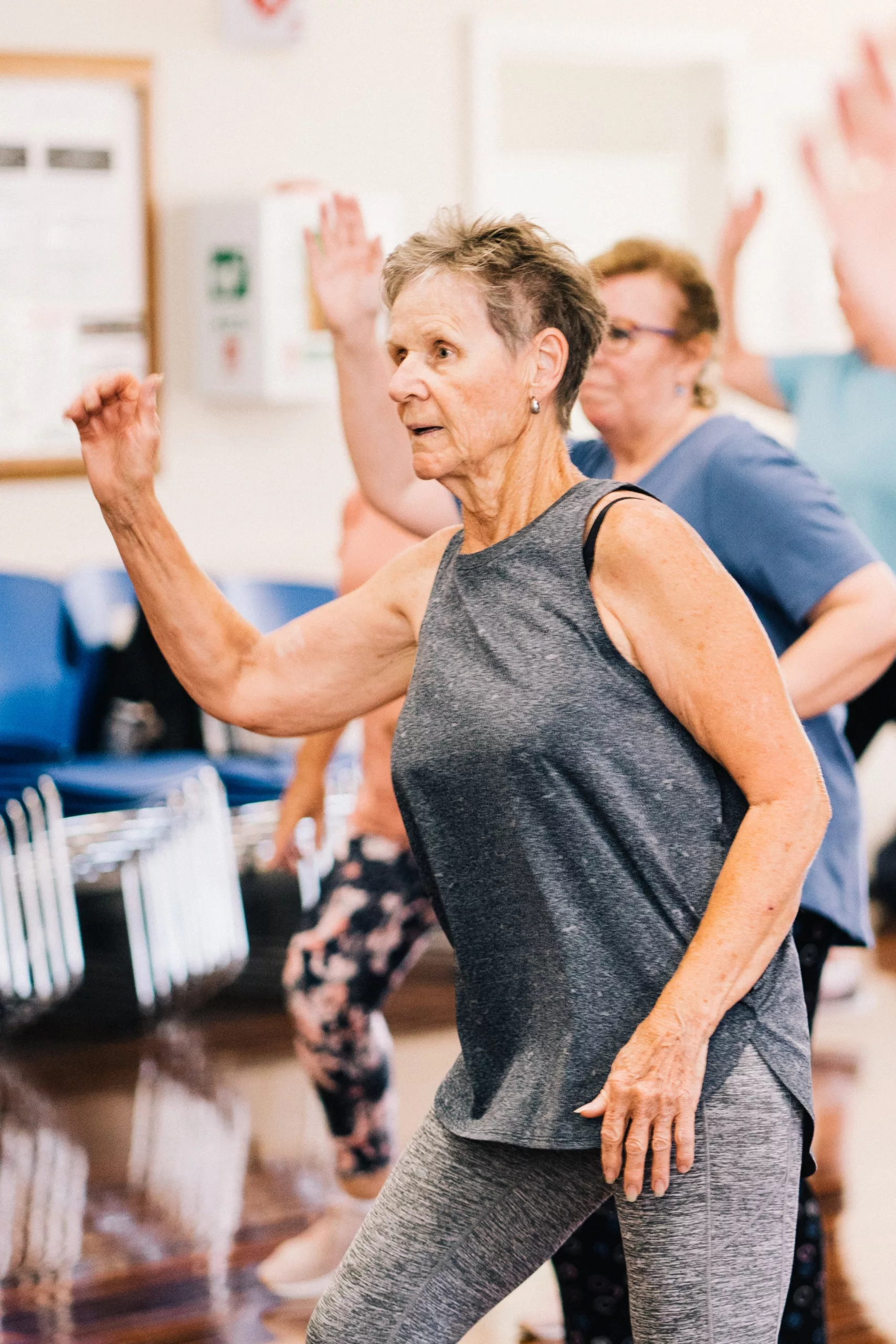 older woman doing an exercise class