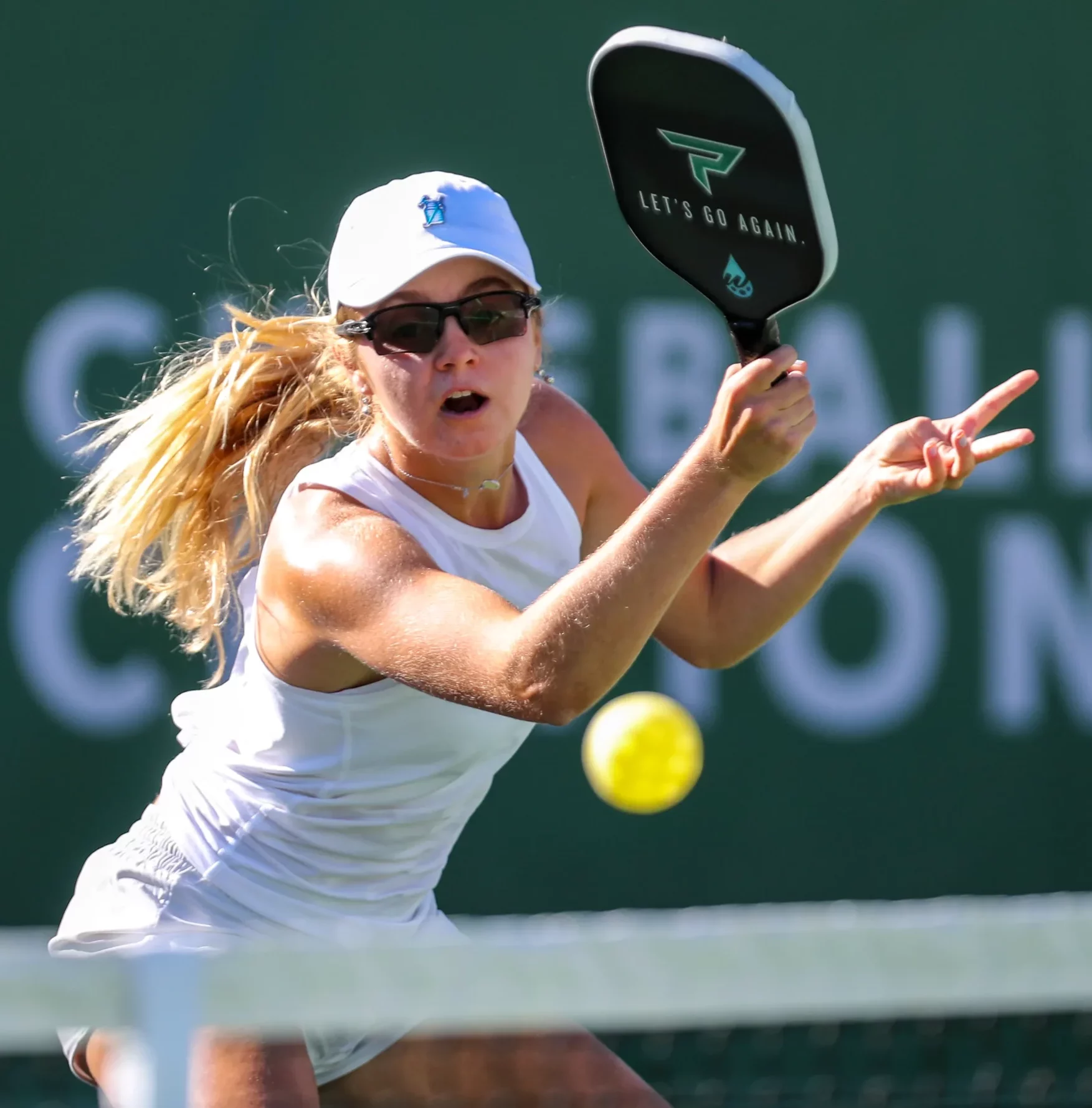Woman playing pickleball in motion